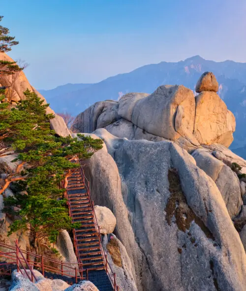 View of stones and rock formations from Ulsanbawi rock peak on sunset with staircase. Seoraksan National Park, South Corea