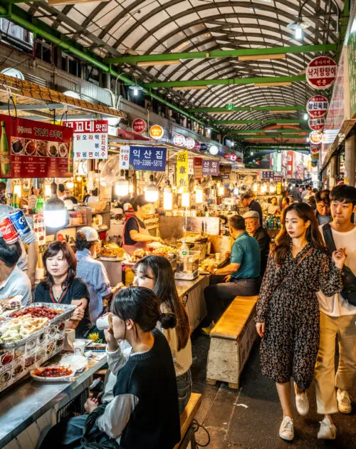 Seoul Korea , 21 September 2019 : View of an alley of the Kwangjang market at night with people eating street food at stalls